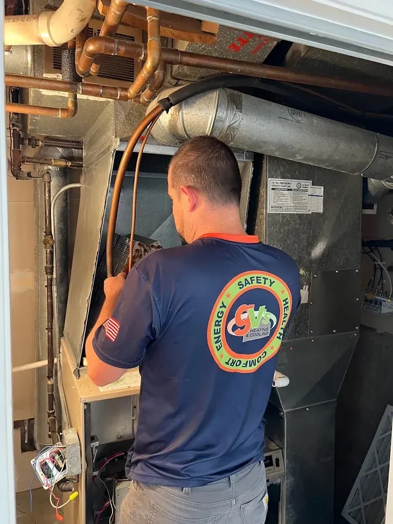 HVAC Blog 2 Technician working on HVAC equipment in a mechanical room.